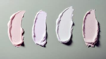 Green background with four cream smears in different shades and textures photo