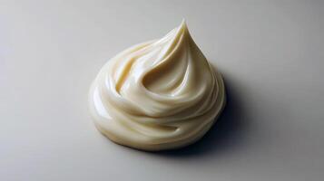 Swirl of creamy beige mayonnaise on light background photo
