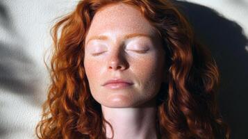 Young caucasian female with red hair relaxing in sunlight photo