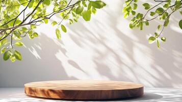 Round wooden platform in bright sunlight with green leaves and shadows photo