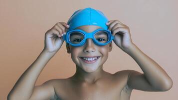 Young hispanic boy ready for swimming with blue cap and goggles photo