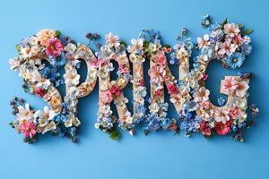 Vibrant floral arrangement spelling spring on blue background photo