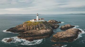 An aerial view of a lighthouse on a rocky island photo