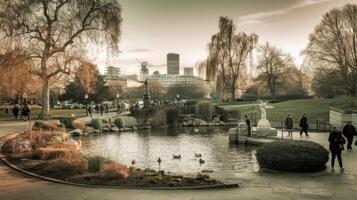 People walking around a pond in a park with a city in the background photo