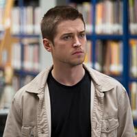 A man in a library looking away from the camera photo