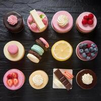 Many different types of cakes on a black table photo