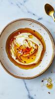Delicious tahini drizzled with honey and a hint of sea salt in a rustic bowl photo