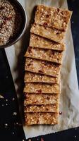 Enjoying millet crackers with sun-dried tomatoes on a rustic table setting perfect for an afternoon snack with friends photo