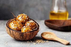Marinated mushrooms with sesame seeds in a rustic coconut bowl against a textured background photo
