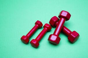 small dumbbells on green background photo