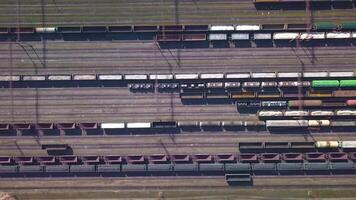 Aerial view of Railway sorting station and A lot of wagons at a railway. Drone flies over railway tracks. 4k quality video
