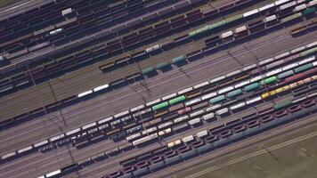 Aerial view of Railway sorting station and A lot of wagons at a railway. Drone flies over railway tracks. 4k quality video