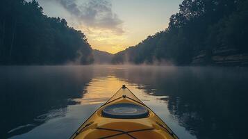A kayak is in the water at sunset photo