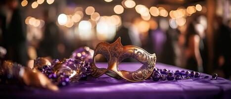 A vibrant masquerade mask rests on a purple table, surrounded by festive beads, with warm bokeh lights in the background, evoking a celebratory atmosphere. photo