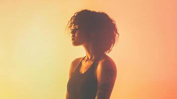 A silhouette of a person with curly hair against a colorful gradient background, evoking a sense of introspection and mood. photo
