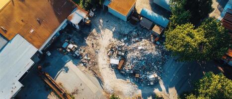 ESG Investing Trends Concept. Aerial view of a construction site with debris, machinery, and surrounding foliage, showcasing industrial activity and land use. photo