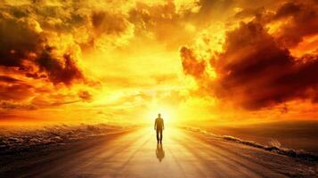 A lone figure walks towards a vibrant sunset, surrounded by dramatic clouds and a reflective road, symbolizing hope and new beginnings. photo