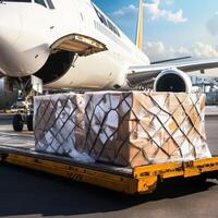 Smart Global Logistics Concept. Cargo pallets are loaded onto an aircraft at an airport, showcasing logistics and air freight operations under a clear blue sky. photo