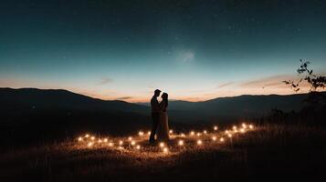 A romantic silhouette of a couple standing amidst glowing lights on a serene hillside during twilight, surrounded by mountains and a colorful sky. photo