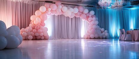 A beautifully decorated event space featuring an arch of pastel balloons, elegant drapes, and soft lighting, perfect for celebrations. photo