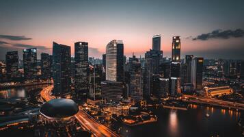 A stunning aerial view of a modern city skyline at dusk, showcasing illuminated skyscrapers and a tranquil river. photo