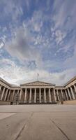 Neoclassical facade of the British Museum in London, with its symmetrical columns, emphasizes the museum historic legacy under an open sky. photo