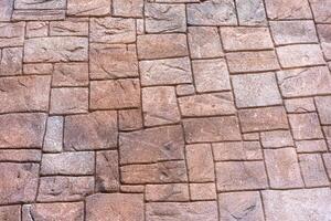 The stone wall is patterned in light brown to nes, each cube is different, small and large alternately. photo
