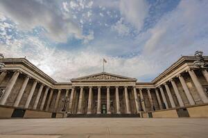 The British Museum impressive columns and symmetrical architecture showcase neoclassical design, highlighting its significance against the vast London sky. photo