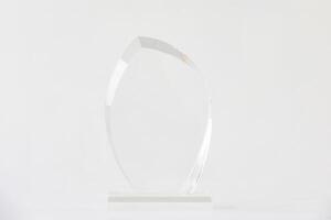 The shot of the blank transparent glass awa rd trophy on a white background, the custom laser cut of the transparent crystal prize. photo