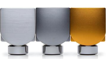 Close-up of three metallic bottle caps in silver, gold, and brushed aluminum on a white background photo