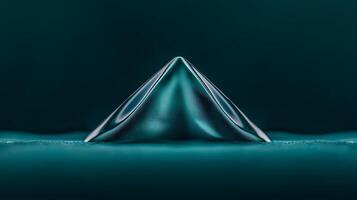 Close-up view of a sleek, teal pyramid shape on a smooth surface, showcasing fluid dynamics photo
