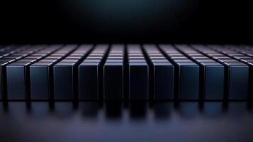 Close-up view of a series of glossy black blocks arranged in a grid pattern on a dark surface photo