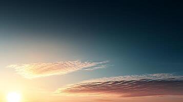 Serene sunset over a vast horizon with soft clouds reflecting warm colors in the sky photo