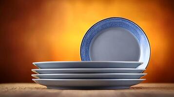 Stacked plates with intricate blue design against a warm, glowing background photo