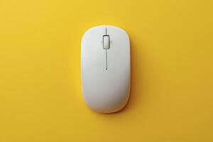 A white computer mouse on a yellow background photo