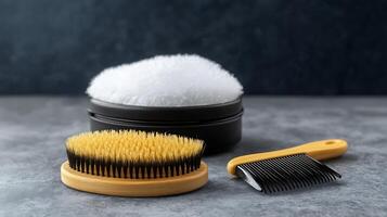 A grooming set featuring a brush, comb, and fluffy powder, arranged on a textured surface photo