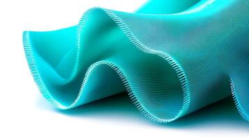 Close-up of flowing turquoise fabric showcasing texture and wave patterns, suitable for design photo