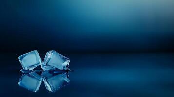 Two ice cubes melting on a reflective surface with a soft blue background, evoking freshness photo