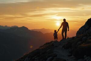 A man and child walking up a mountain at sunset photo