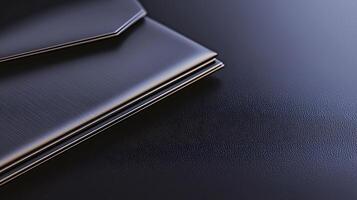 A close-up view of sleek black envelopes resting on a textured dark surface, showcasing elegance photo