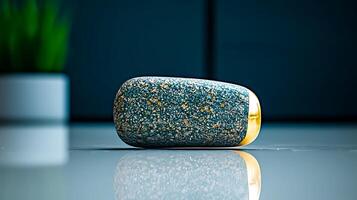 A close-up view of a textured stone object with a golden accent on a reflective surface photo