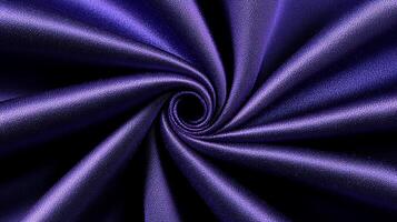 Close-up of a swirling purple fabric showcasing smooth texture and rich color depth photo
