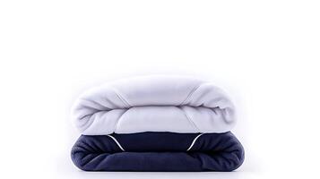 Soft, rolled blankets in white and navy blue stacked on a clean background, ideal for home decor photo