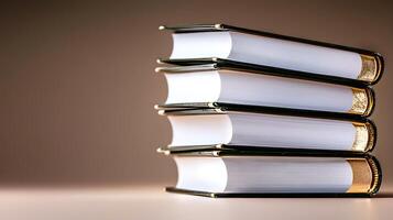 Stacked books with golden edges on a neutral background, creating a serene study atmosphere photo