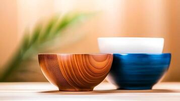 Three beautifully crafted bowls in warm tones arranged on a wooden surface with a blurred background photo