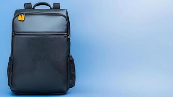 Sleek black backpack against a soft blue background, showcasing minimalist design and functionality photo