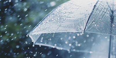 A clear umbrella is open in the rain photo