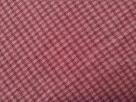 The background and pattern of the fabric is seamless alternating red checkered material photo