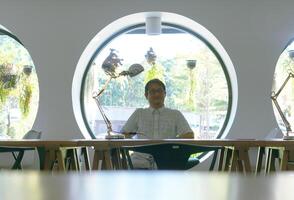Thai man in Modern Office with Circular Windows photo