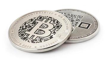 Silver coins featuring Bitcoin symbol and QR codes, representing digital currency photo